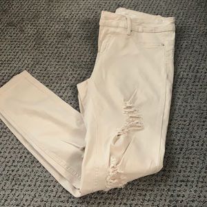 Blush pink distressed skinny jeans